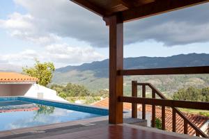 a view from the balcony of a house with a swimming pool at Gondoriz-House in Terras de Bouro