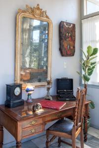 a desk with a mirror and a laptop on it at DellaGracia Mansion in Poseidonia Syros in Posidhonía