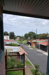 a view from a window of a small town street at The Gardens in San José