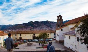 a view of a town with a clock tower at Hostal sambleño cusco Piero suite in Cusco