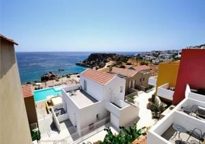 a group of buildings on a beach with the ocean at Apolis Beachscape Hotel in Amoopi