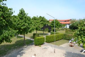 a man is standing in a park with an umbrella at Vakantiewoning De Zandkorrel in Middelkerke