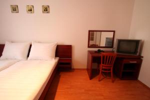Televízia a/alebo spoločenská miestnosť v ubytovaní Apart Hotel Susa
