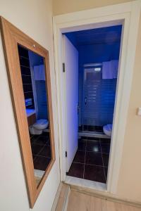 a bathroom with two toilets and a mirror at Villa Vongole in Cesme +65 photos