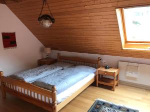 a bedroom with a bed in a room with a window at Jizerka in Unterwasser