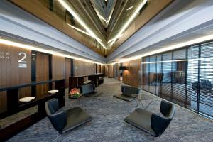 a lobby with chairs and desks in a building at Hotel Badalona Tower in Badalona