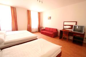 Televízia a/alebo spoločenská miestnosť v ubytovaní Apart Hotel Susa