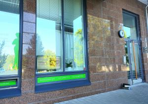 a brick building with four windows with a clock on it at Uniq Home Helsinki in Helsinki