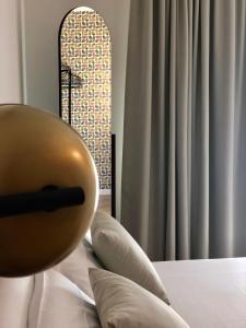 a orb sitting on top of a bed with pillows at Metropolitan Suites in Ancona
