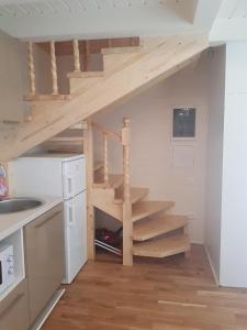 a kitchen with a wooden staircase in a house at Advance in Narva-Jõesuu