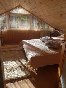 a bedroom with two beds in a wooden house at Advance in Narva-Jõesuu