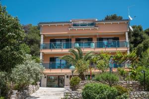 a building with a balcony on the side of it at Villa Magnolia in Mali Lošinj
