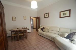 a living room with a white couch and a table at La casa di GB in Pieve di Teco