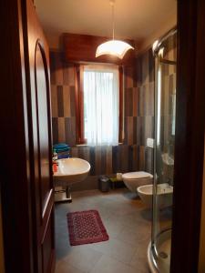 a bathroom with two toilets and a sink and a shower at Appartamenti Altea in Sirmione