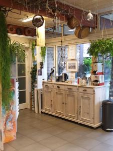 a kitchen with wooden cabinets and a counter top at Appartementen Het Oude Atelier in Schoorl