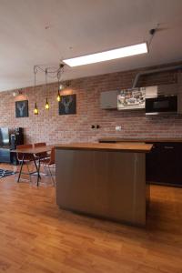 a kitchen with a counter and a brick wall at Bajka 09 -Self Check - Free parking in Bratislava