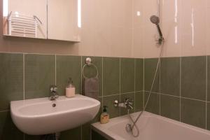 a bathroom with a sink and a shower at Bajka 09 -Self Check - Free parking in Bratislava +29 photos