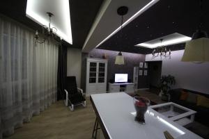 a living room with a white table and a couch at MAJESTIC Residence in Braşov