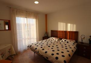 a bedroom with a bed with a polka dot blanket at Casa Antonio in Águilas