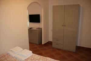 a room with a bedroom with a dresser and a mirror at Apartments Chemenko in Konsko