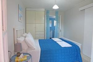 アルテミダにあるCalypso Apartmentsのベッドルーム(青いベッド1台、青い毛布付)