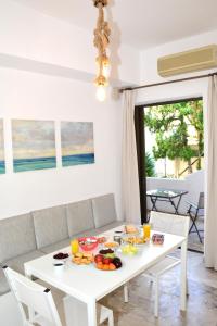 a white table with food on it in a living room at Golden Star Praxitelous in Agia Marina Aegina