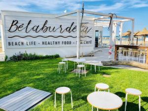 a beach life healthy food sign with chairs and tables at Hotel Doge in Rimini
