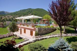 an external view of a villa with a garden at Bucaneve in Pescasseroli