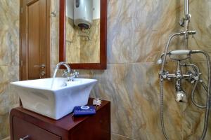 a bathroom with a sink and a shower at Markisia's Luxury Corfu Town Apartment in Corfu