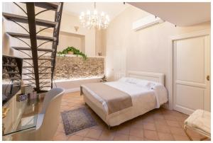 sypialnia z łóżkiem i żyrandolem w obiekcie Boutique - Lodge & Suites w mieście Crotone