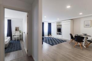 a living room with a table and a dining room at Atlantic Town - Free Parking in Ponta Delgada