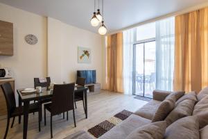 a living room with a couch and a table at GOLD BUGAZZ in Gribovka