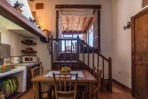 a kitchen with a table with chairs and a staircase at Casa Gaida in Tías