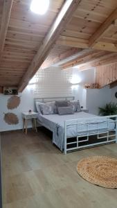 a large bed in a room with a wooden ceiling at Amazing in Haifa