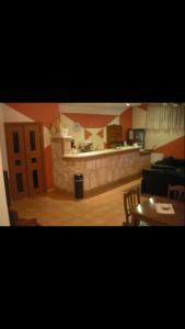 a living room with a kitchen and a counter at La Dimora di Federico in Gravina in Puglia