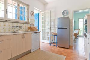 a kitchen with a stainless steel refrigerator in a room at Maureen's beach house in Forte dei Marmi
