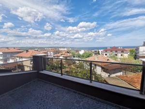 a balcony with a view of the city at Kazak in Obzor