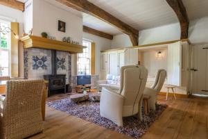 a living room with a couch and a fireplace at Hoeve de Eshof in Norg