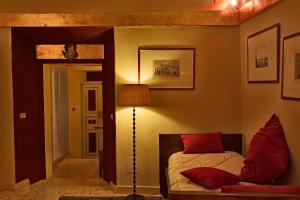 a bedroom with a bed and a lamp and a mirror at Residenze Gregoriane - Residenza d'Epoca in Tivoli +75 photos