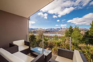 a room with a view of a lake and mountains at Shotover Ridge in Queenstown