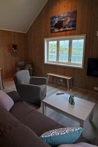 a living room with a couch and a table at Lofoten Cabins - Kåkern in Ramberg