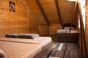 sypialnia z 2 łóżkami w drewnianym domku w obiekcie KOLIBA A&A w mieście Kolašin