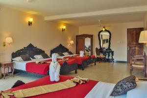 Кровать или кровати в номере Tembo House Hotel