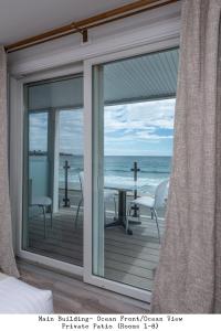 a room with a window looking out at the ocean at Stones Throw in York Beach