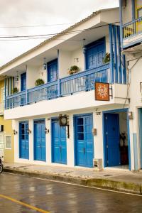 a building with blue doors on a street at El Reloj Casa Hotel in Filandia