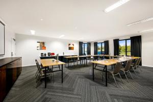 a conference room with tables and chairs and windows at Quest Moorabbin in Moorabbin