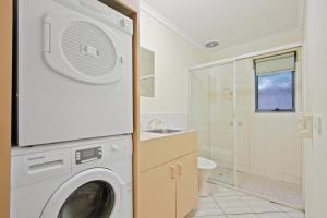 a washing machine in a bathroom with a sink at North Pier Hotel in Cowes