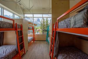 a room with four bunk beds and a window at Canmore Downtown Hostel in Canmore