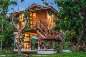 a tree house in the middle of a forest at baanchandra in Chiang Mai