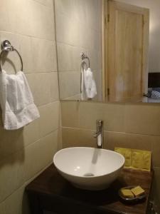 bagno con lavandino bianco e specchio di Estancia del Monje a Cobán